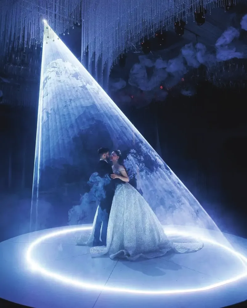 Couple on stage under a laser light effect
